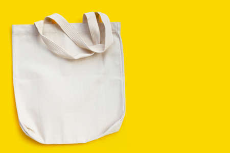 White fabric bag on yellow background.の写真素材