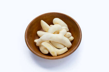 Young ginger peeled in wooden bowl on white background.の写真素材
