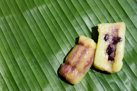 Bundled boiled rice on banana leafの写真素材
