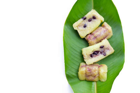 Bundled boiled rice on green leaf on whiteの写真素材