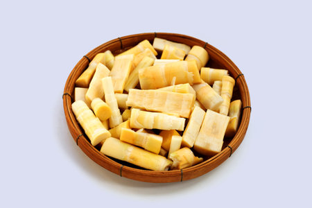 Bamboo shoots in bamboo basket on white background.の写真素材