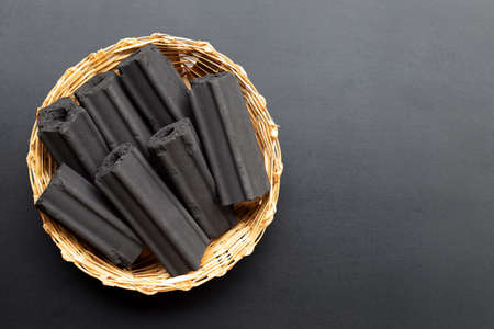 Non smoke wood charcoal in bamboo basket on white background.の写真素材