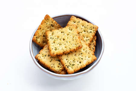 Seaweed crackers in bowl on white background.