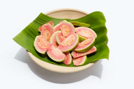Fresh pink guava on banana leaf in plate on white background.の写真素材