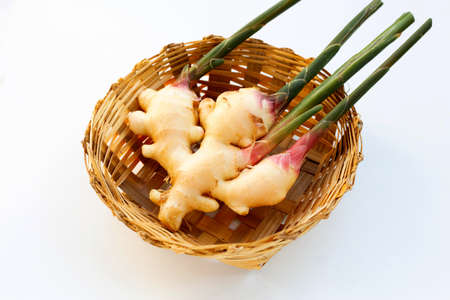 Ginger in bamboo basket on whiteの写真素材