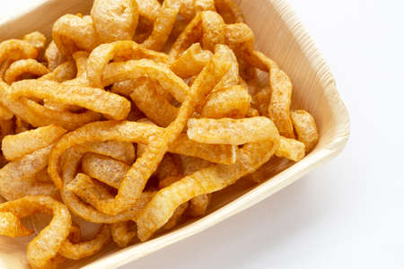 Fried crispy pork rinds in plate on white background.の写真素材