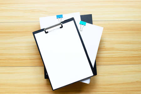 Paper with office folder on wooden table background. Top viewの写真素材