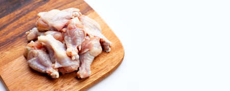 Fresh raw chicken wings (wingstick) on wooden board on white background.の写真素材