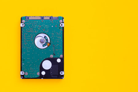 Hard disk drive of computer on yellow background.の写真素材