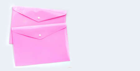 Pink plastic folders on white background.の写真素材