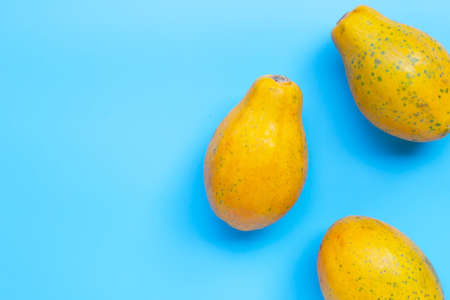 Papaya fruit on blue background. Top viewの写真素材