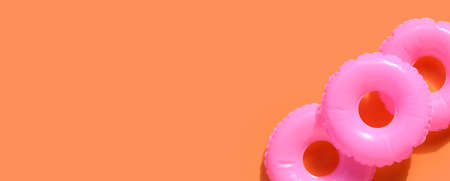 Inflatable rings on orange background. Summer background conceptの写真素材