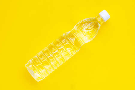 White vinegar bottle on yellow background.の写真素材