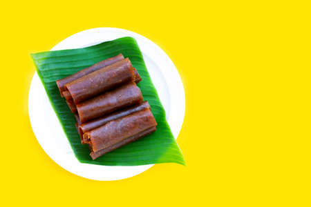Dried mango paste on yellow background.の写真素材