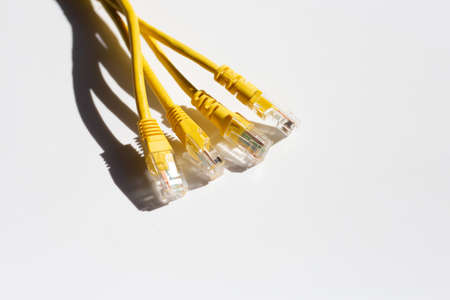 LAN network connection yellow cables on whiteの写真素材