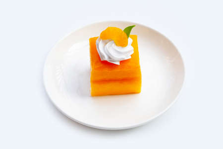 Orange cake in white plate on white background.の写真素材