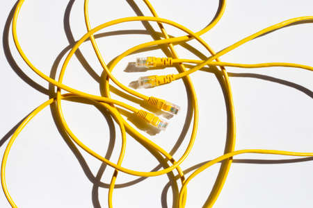 LAN network connection yellow cables on whiteの写真素材