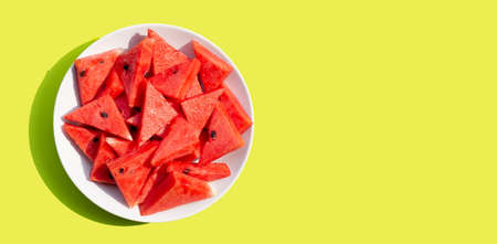 Watermelon in white plate on green background.の写真素材