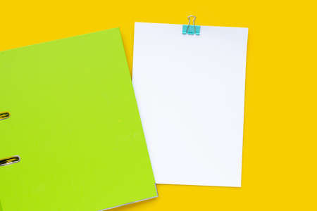 Office folder with papwer on yellow background. Top viewの写真素材