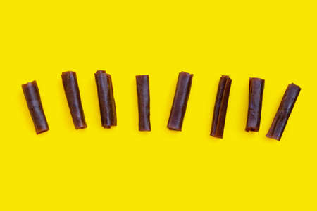 Dried mango paste on yellow background.