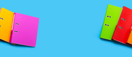 Office folders on blue background. Top viewの写真素材