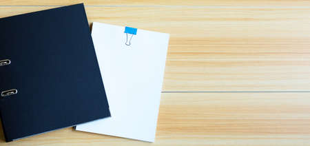 Office folders on wooden texture background.