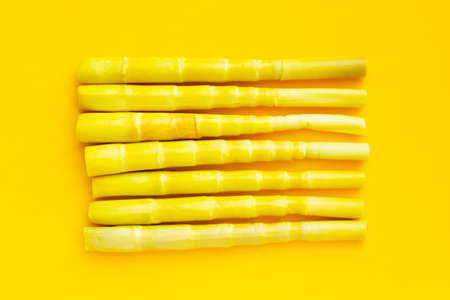 Preserved bamboo shoots on yellow background.の写真素材
