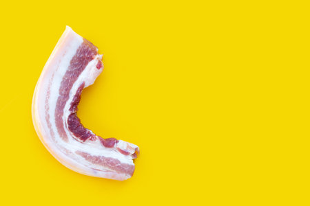 Streaky pork on yellow background.の写真素材