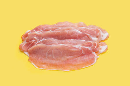 Sliced raw pork meat on yellow background.の写真素材
