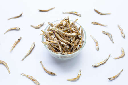 Dried anchovy in glass bowl on white background.の写真素材