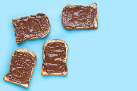 Bread with sweet chocolate hazelnut on blue background.の写真素材