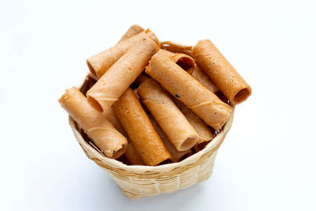 Thai crispy coconut rolls on white background.