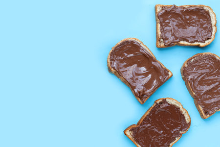Bread with sweet chocolate hazelnut on blue background.の写真素材