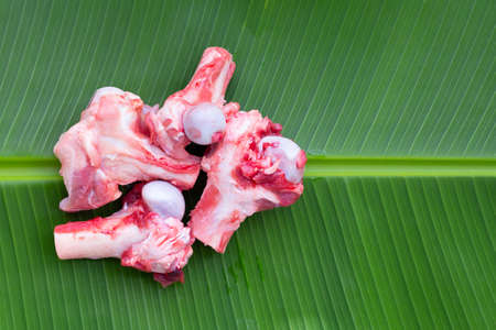 Raw pork bones on banana leafの写真素材