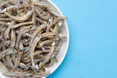Dried anchovy in white on blue backgroundの写真素材