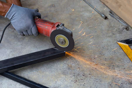 Close up, A man working with angle grinder. Iron gate repairの写真素材