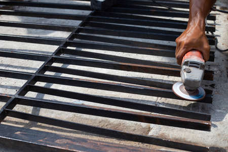 Close up, A man working with angle grinder. Iron gate repairの写真素材