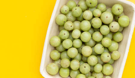 Fresh emblica in plate on yellow background.の写真素材