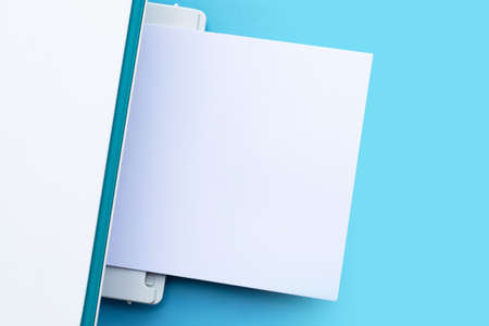 Printer and paper on blue background.