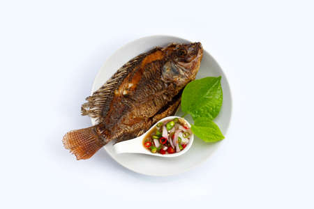 Fried fish in white plate on white background.