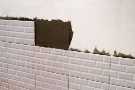 House renovation, Laying ceramic tiles on the wall.の写真素材