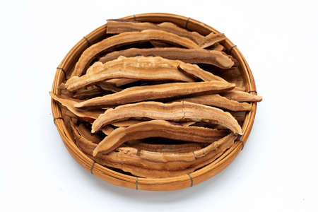 Dried lingzhi mushroom slices in bamboo basket on white backgroundの写真素材