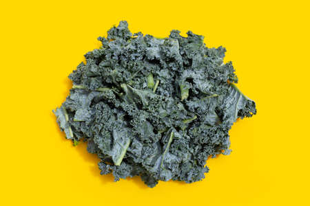 Kale leaves on yellow background.