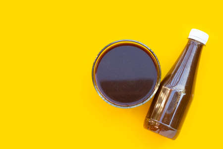 Strong pickled fish sauce on yellow background.