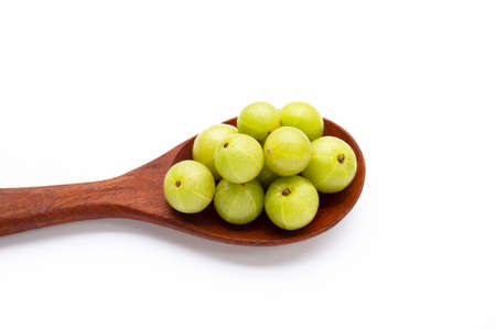 Fresh emblica in wooden spoon on white background.の写真素材