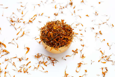 Dried marigold flower petals on white background. Flower herbal tea concept.の写真素材