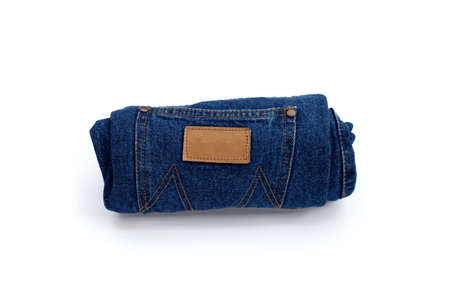 Rolled blue jeans on white background