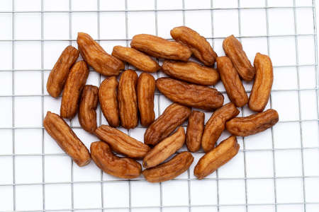 Sun-dried bananas on white background.
