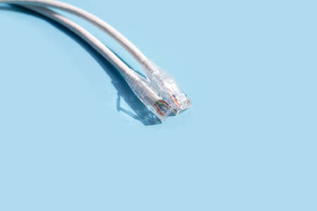 LAN network connection ethernet white cables on blue background.