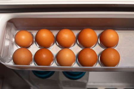 Raw chicken eggs in fridgeの写真素材